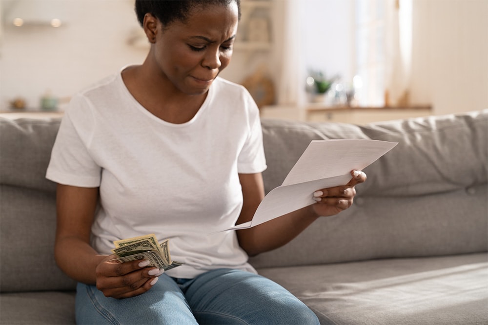 Stressed woman with a bill who needs bankruptcy advice