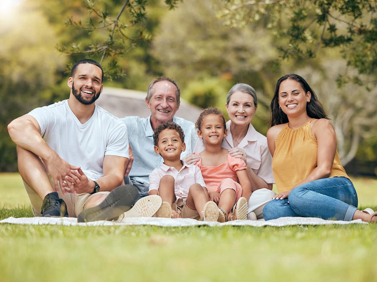 multi-generational family sitting at a picnic